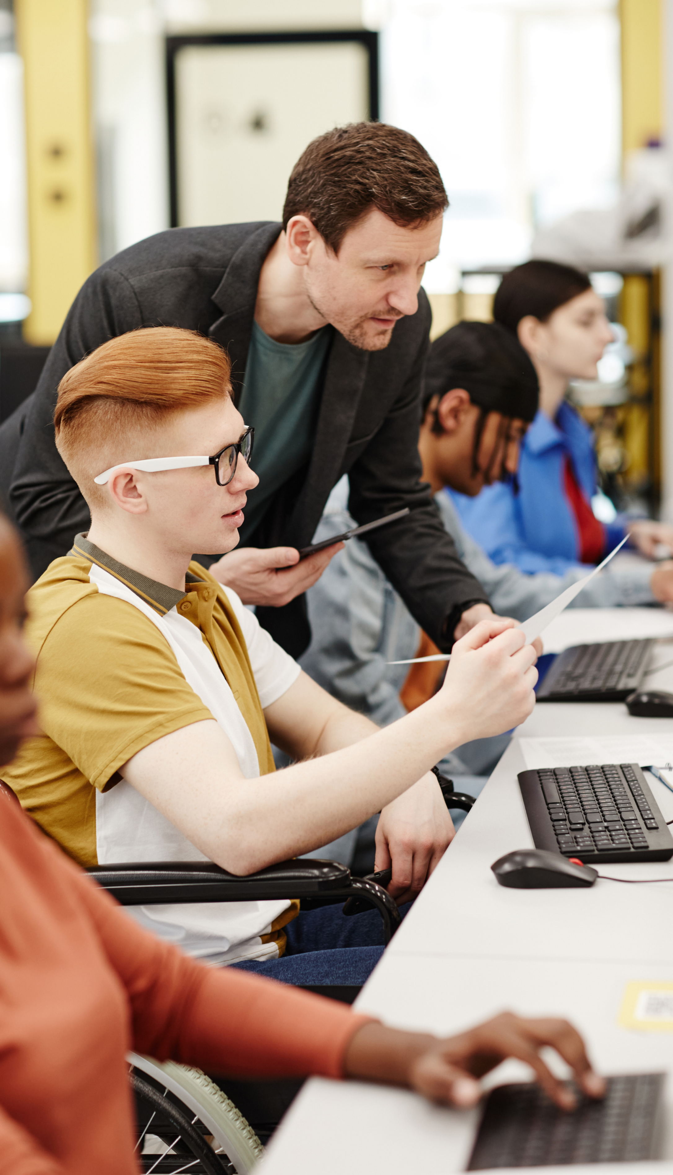 Hands-on network security training in a lab environment with multiple monitors displaying network diagrams and security tools.